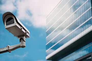 Security camera with a glass building on the background