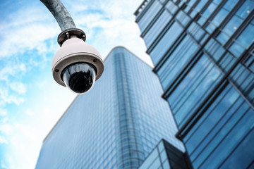 Security camera with a glass building on the background
