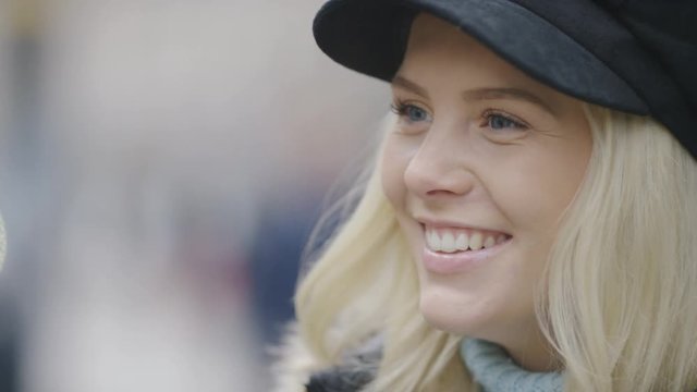 Young female responding during a conversation out in the street