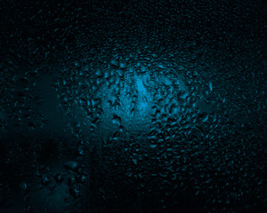 contrast drops on the glass, blue tint, dark fogged glass, texture, background 