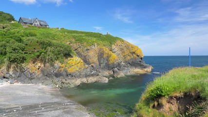 Pan shot of the beautiful Cornish seaside travel destination of Cadgwith Cove, Cornwall, England.