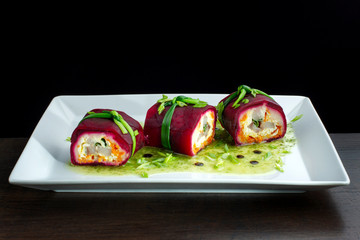 Salad with herring, beets, carrots, onions, potatoes and eggs on a plate.