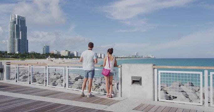 Miami tourists people city lifetyle - young urban couple on travel on South Beach, Miami, Florida RED Cinema Camera in SLOW MOTION.