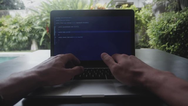 first-person portrait programmer developer programmer freelancer writes code at a laptop outside the office