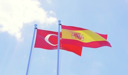 Turkey and Spain, two flags waving against blue sky. 3d image