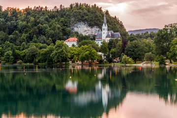 Lake Bled, Slovenia, in Alps mountains. Amazing view to the lake and and catholic church reflected in water at sunset. Travel Slovenia.