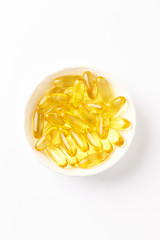 Fish oil capsules with omega 3 on white background. Top view. Copy space. 