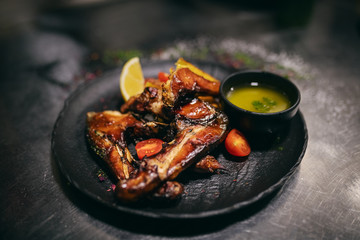 Close up of smoked carp on top of potato salad. On plate little bowl of soup.