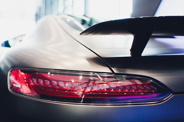rear spoiler on a grey english sportscar.