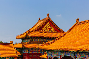 Naklejka premium Traditional Chinese architecture with yellow roof tiles, in Forbidden City, under blue sky, in Beijing, China