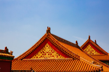Fototapeta na wymiar Traditional Chinese architecture with yellow roof tiles, in Forbidden City, under blue sky, in Beijing, China