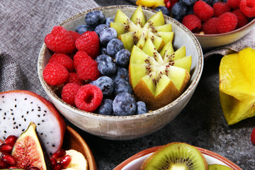 fruit bowl. Bowl of healthy fresh fruit salad on rustic background