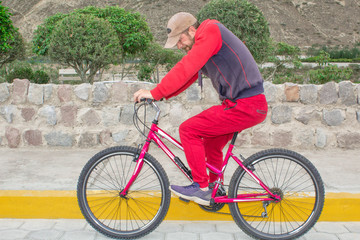 Fototapeta premium A man on a bicycle in the open air, rides along the road. Sports events, sports riding.
