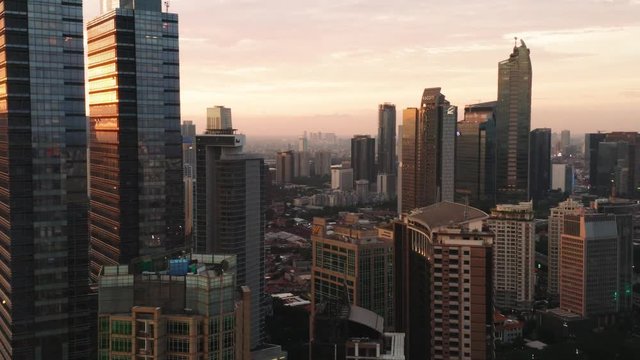 JAKARTA, Indonesia - January 02, 2019: Beautiful aerial landscape of modern skyscrapers in financial district at dusk time. Shot in 4k resolution