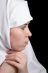 Young nun in white dress, facial closeup portrait