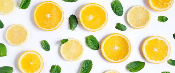 Fototapeta na wymiar Photo of orange and lemon slices with mint on a white background. Background for the design of banners, websites, blogs, information block. Frame for banner with orange and lemon