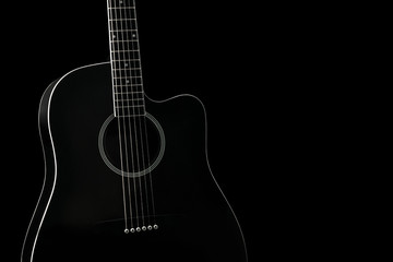 Fototapeta na wymiar Black acoustic guitar isolated on black background