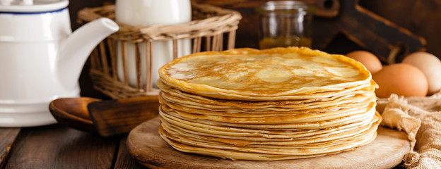 Homemade thin crepes with honey, pancakes on wooden rustic background - obrazy, fototapety, plakaty