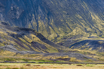 Iceland barren landscape view of rocky mountain cliff foothill during day on south southern ring road or golden circle