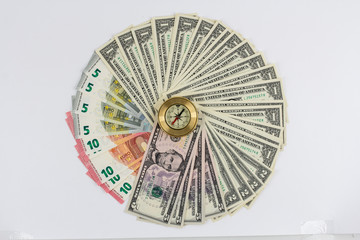 Banknotes dollars and euros are fan in a circle on a white backg