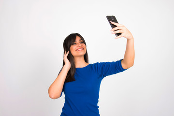 Girl on white with smartphone cell phone smiling using  internet social media concept 