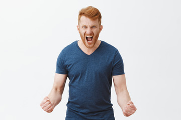 Feel my fury. Portrait of outraged angry and pissed strong masculine redhead male with bristle,...