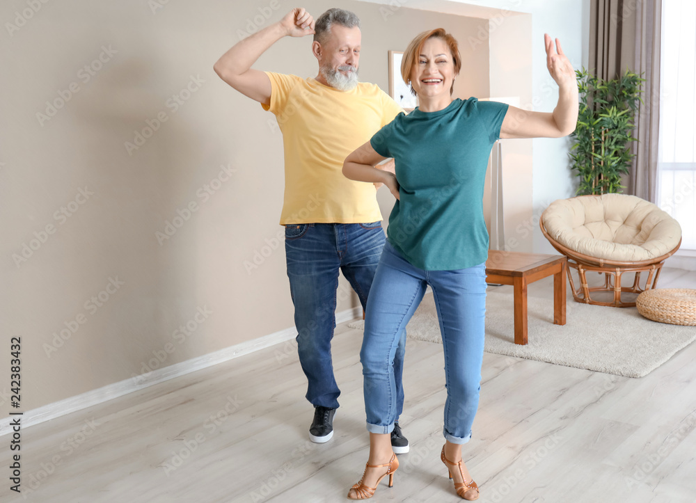 Wall mural Happy mature couple dancing at home