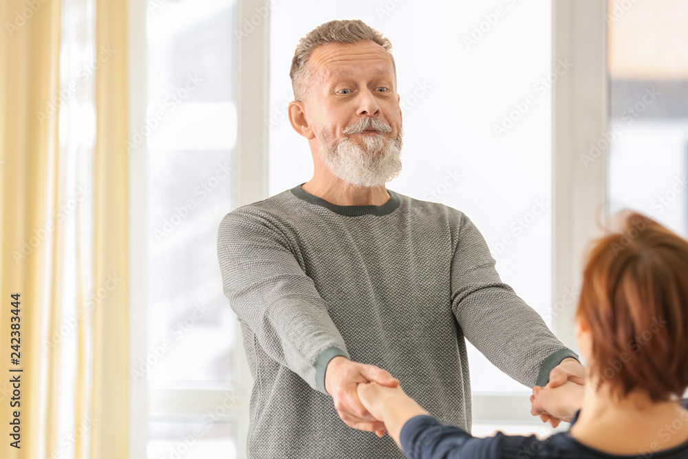 Sticker happy mature couple dancing at home