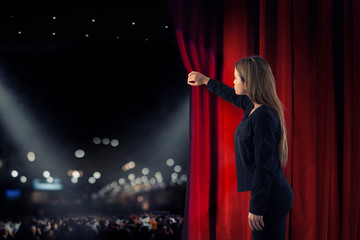 Woman open red curtains of the theater stage - obrazy, fototapety, plakaty