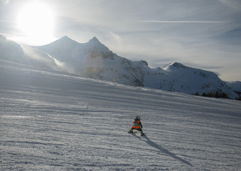 Stunning view of the mountains and child skier in Obertauern ski resort