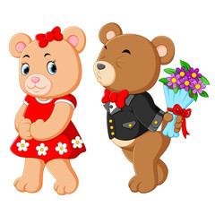 two cute bears using the best costume and the boy taking the flowers