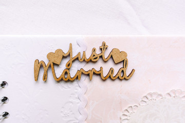 Valencia, Spain - October 20, 2018: Wooden sign with the word Just Married on a photo book...