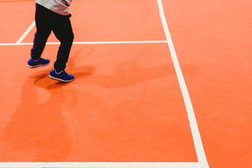 Obraz premium Child playing tennis near the white lines of the court.