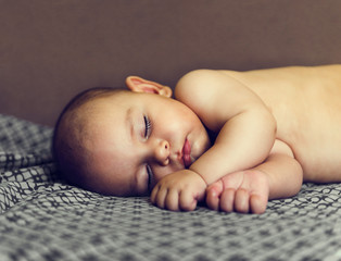 cute baby sleeps on side summer naked bed brown nap