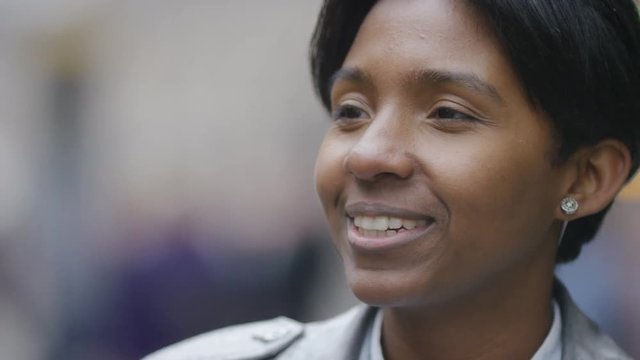 Young transgender man talking and responding to someone off camera in the street