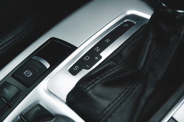 Automatic gear stick inside modern luxury car