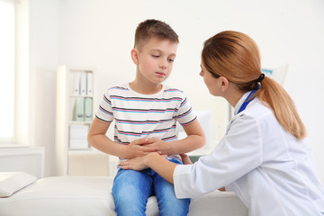 Doctor working with little patient in hospital