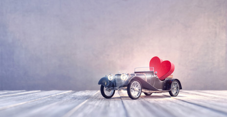 Black Old timer car toy arriving with red heart 3D Rendering