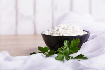 A fresh ricotta cheese with parsley leaf on white marble table