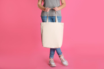 Woman with eco bag on color background. Mock up for design