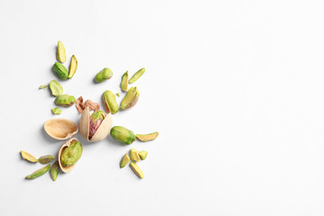 Composition with organic pistachio nuts on white background. Space for text