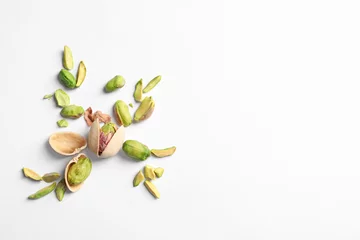 Poster Composition with organic pistachio nuts on white background. Space for text © New Africa