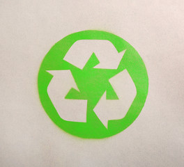 Recycling symbol on cardboard paper, top view