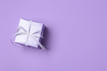 Beautiful gift box on color background, top view with space for text