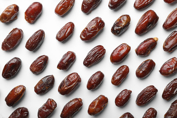 Sweet dried date fruits on white background, top view