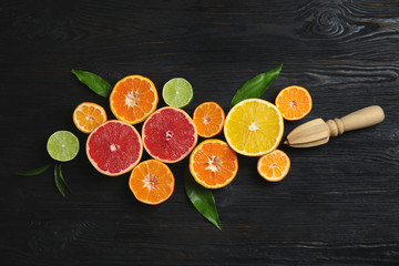 Different citrus fruits on wooden background, flat lay