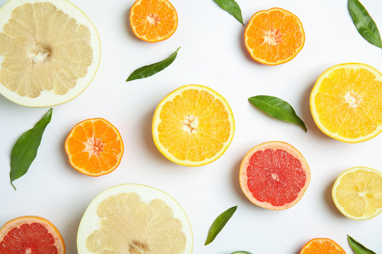 Different citrus fruits on white background, flat lay