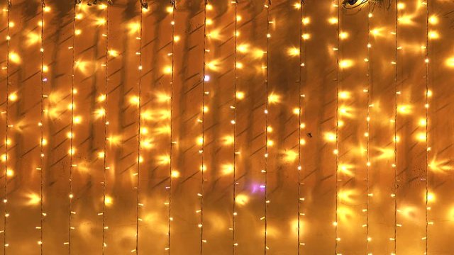 Copy space background with golden Christmas lights in yellow and orange colors.