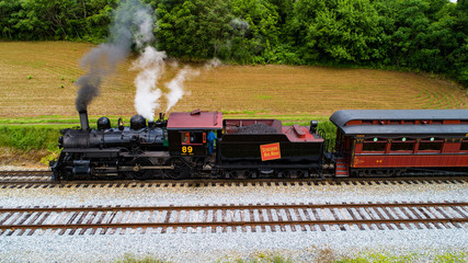 Steam Passenger Train Pulling into Picnic Area by Drone