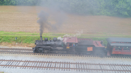 Steam Passenger Train Pulling into Picnic Area by Drone